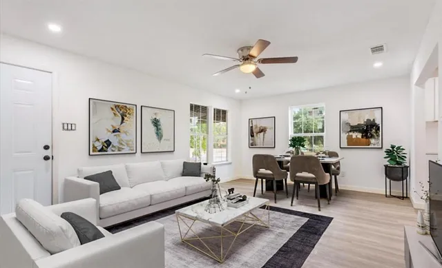 a living room with furniture and wooden floor