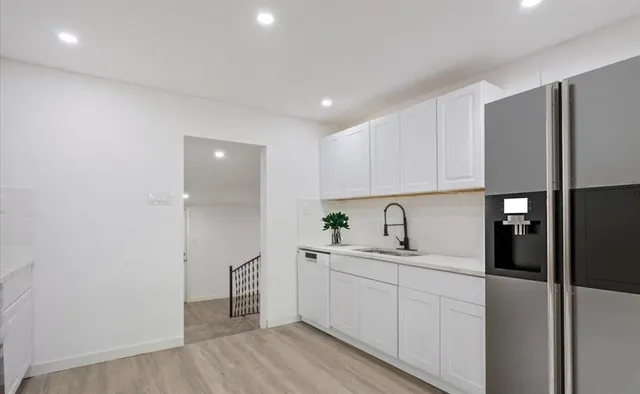 a kitchen with a sink stainless steel appliances and cabinets