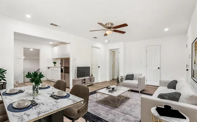 a living room with furniture and view of kitchen