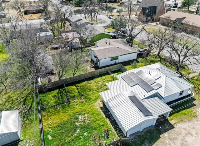 an aerial view of a house with a garden and lake view