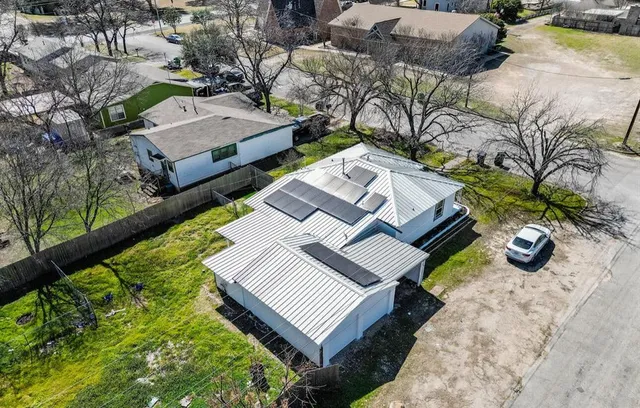 a view of a backyard with chairs and a table