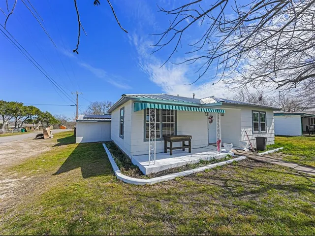 a view of a house with backyard porch and sitting area