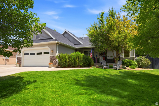 5196 Rodeo Circle Oakley, UT 84055 - Photo 2 of 57 Exterior featuring a two-car garage, stone accents, and a covered front porch