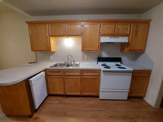 a kitchen with stainless steel appliances a sink stove and cabinets