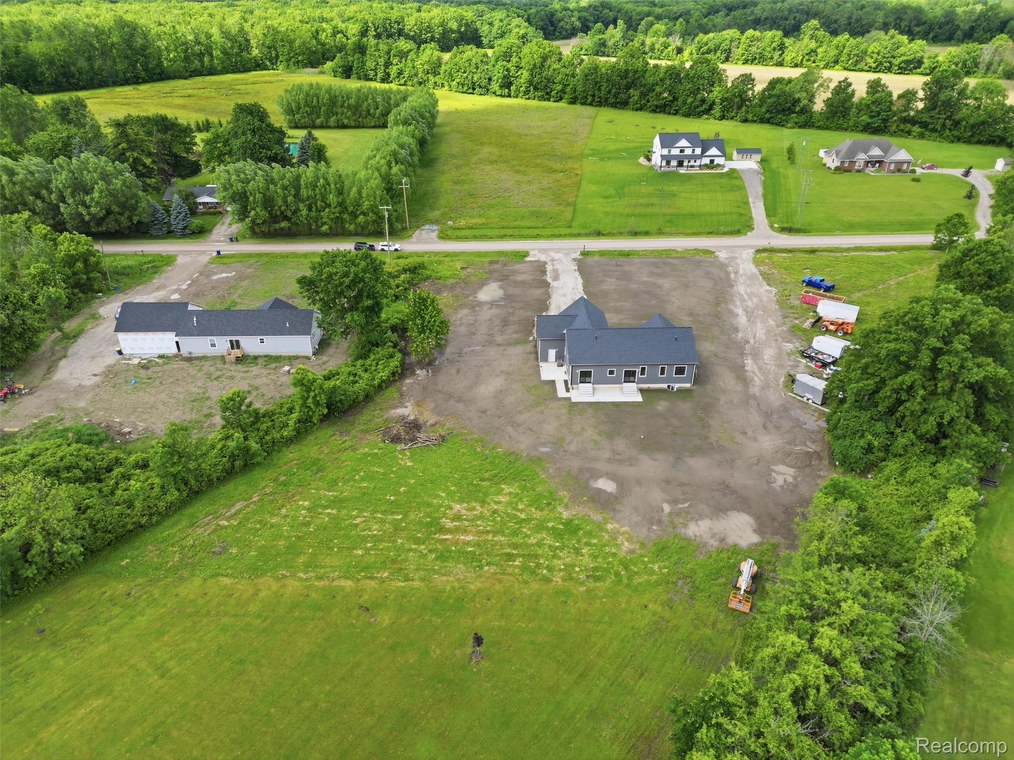 77850 Angling Road Richmond, MI 48062 - Photo 51 of 54 Recently constructed residence featuring a dark gray roof, light gray siding, and multiple windows