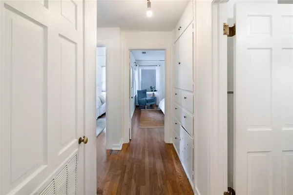 a view of a hallway with a hardwood floor