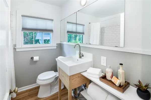 a white toilet sitting next to a bathroom sink