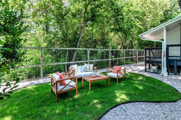 a backyard of a house with table and chairs