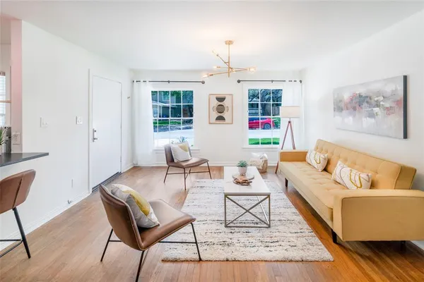 a living room with furniture and wooden floor