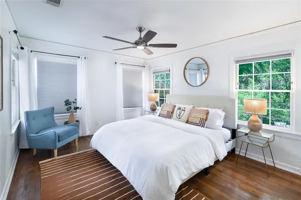 a bedroom with a bed and a chair