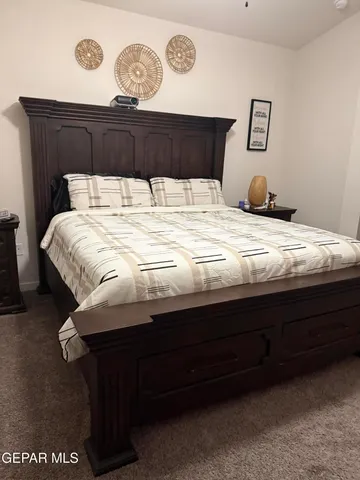 a bedroom with bed and a chandelier