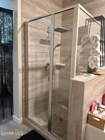 a bathroom with a glass shower door