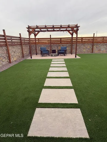 a view of a big yard with table and chairs