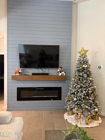 a living room with a flat screen tv and a fireplace