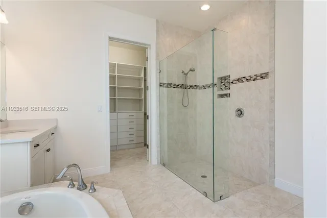 a bathroom with a shower and a sink