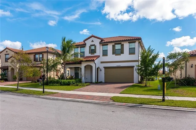 a front view of house with yard and green space