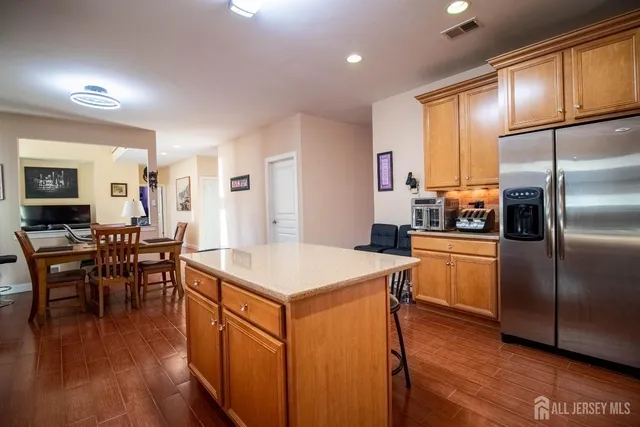 a kitchen with kitchen island a counter top space and stainless steel appliances