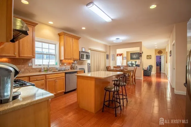 a kitchen with counter top space a sink appliances and cabinets