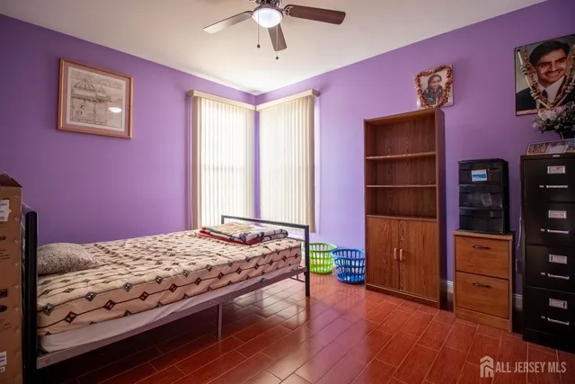 a bedroom with a bed and a television