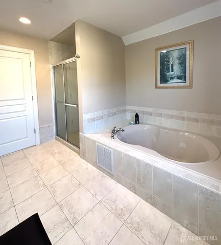 a spacious bathroom with a bathtub and a shower