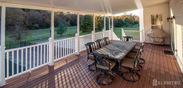 a view of a patio with a table chairs and a backyard