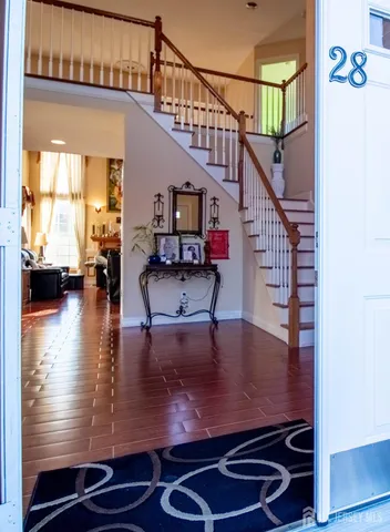 a view of entryway and hall with wooden floor