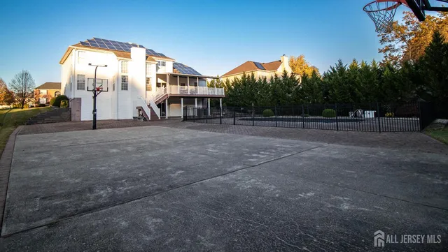 a view of a big house with a big yard and large trees