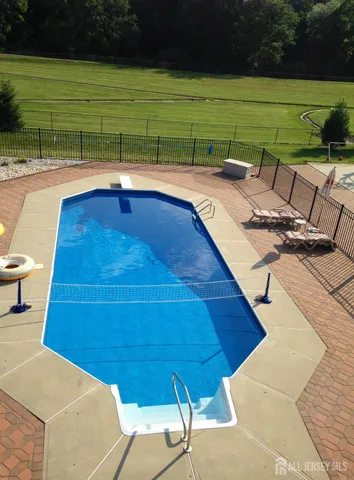 a view of a backyard with a table and chairs under an umbrella