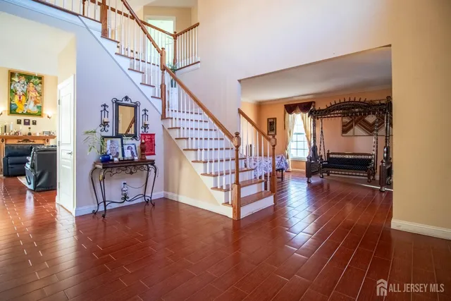 a view of entryway and hall with wooden floor