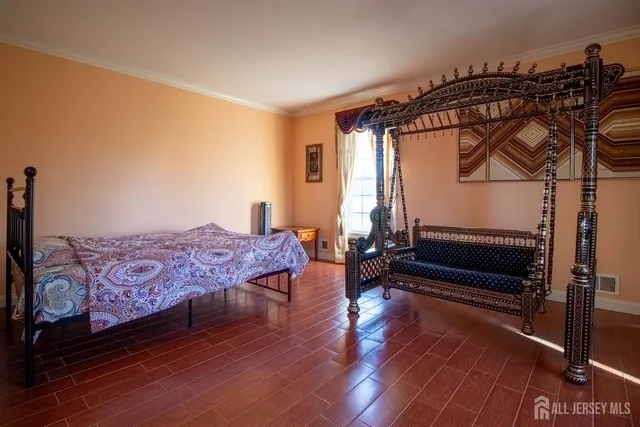 a bedroom with furniture and wooden floor