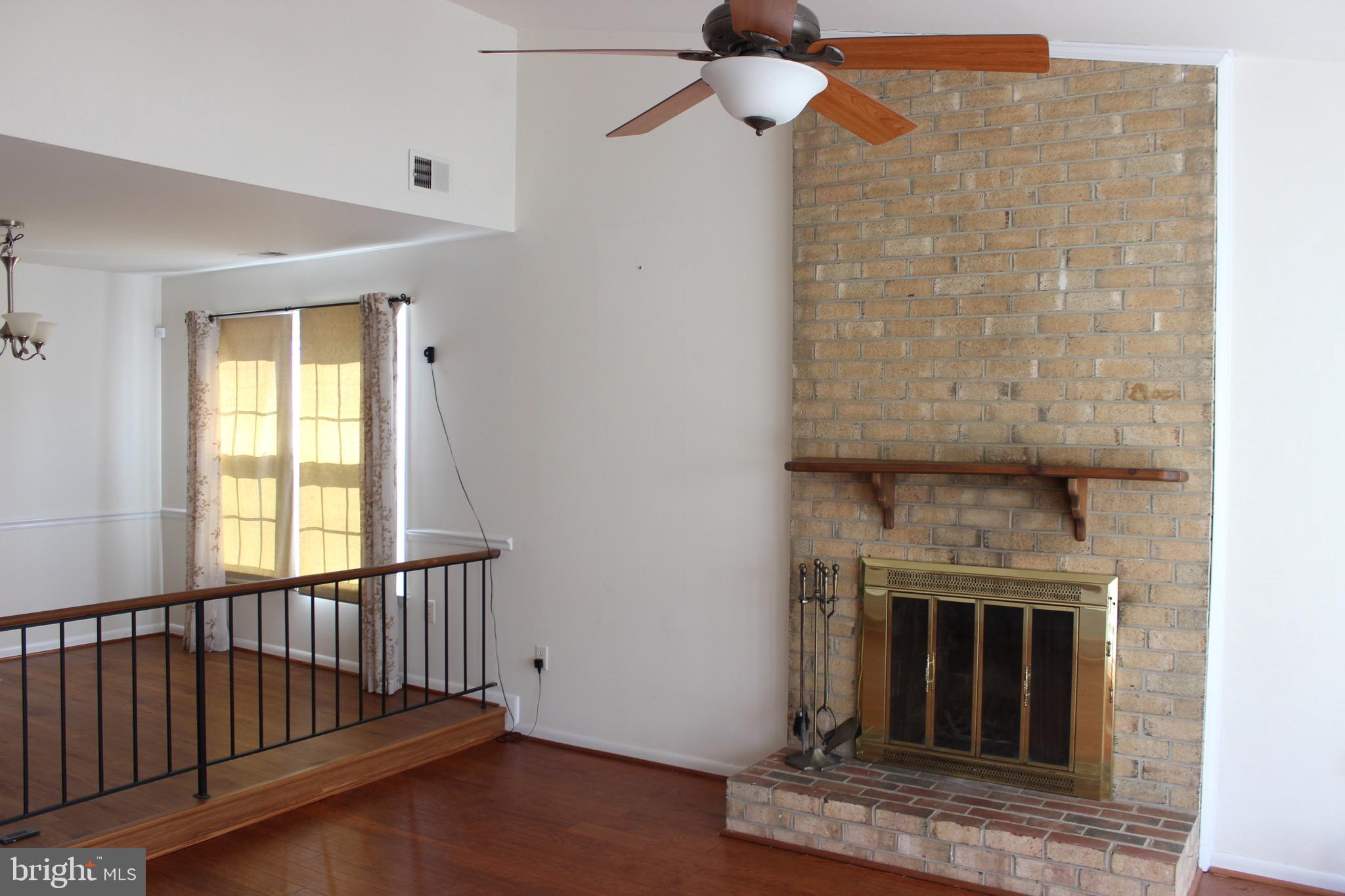 12716 Builders Road Herndon, VA 20170 - Photo 3 of 30 Brick hearth wood burning fireplace