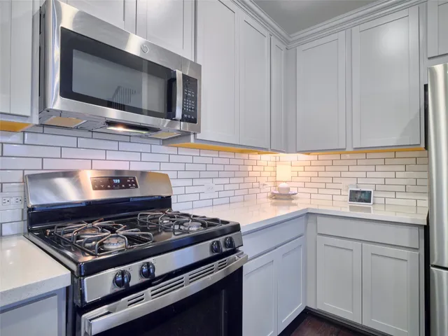 a stove top oven sitting inside of a kitchen