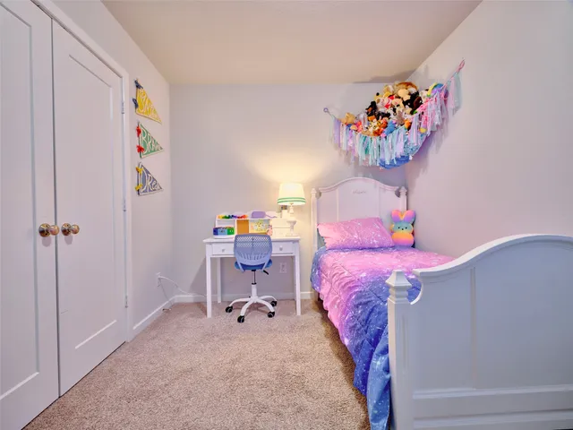 a bed room with a bed and a painting on the wall