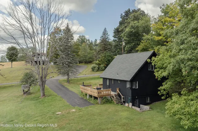 a view of a house with a yard balcony and sitting area