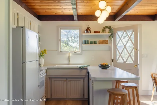 a kitchen with stainless steel appliances a sink cabinets and wooden floor