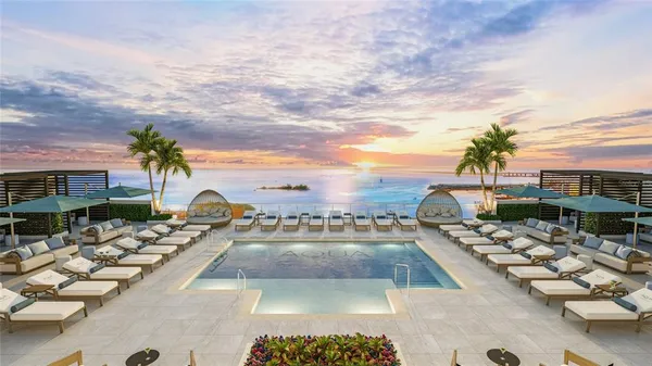 a swimming pool with outdoor seating and city view
