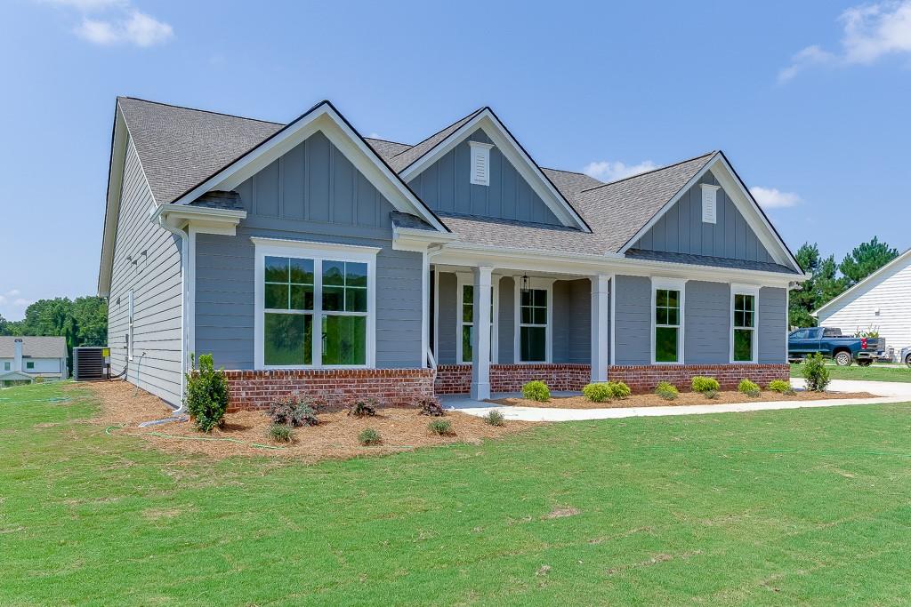 1123 Poppy Lane Jefferson, GA 30549 - Photo 1 of 45 a front view of a house with a yard and porch