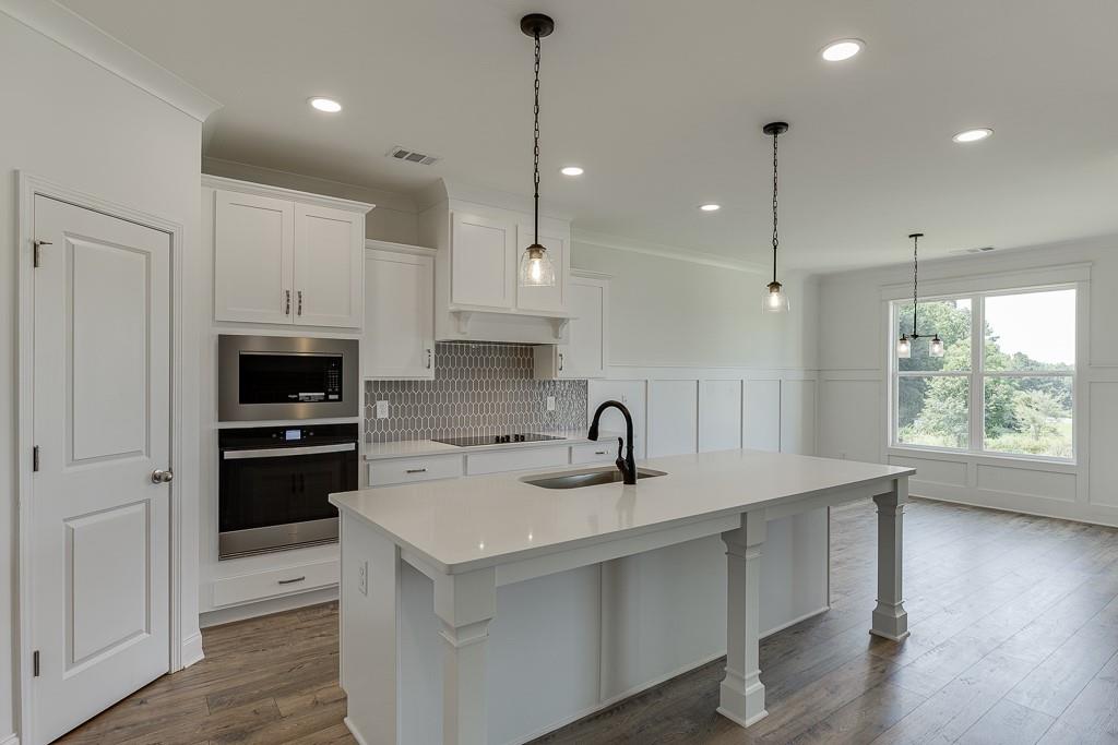 1123 Poppy Lane Jefferson, GA 30549 - Photo 14 of 45 a kitchen with a sink a counter top space stainless steel appliances and a window