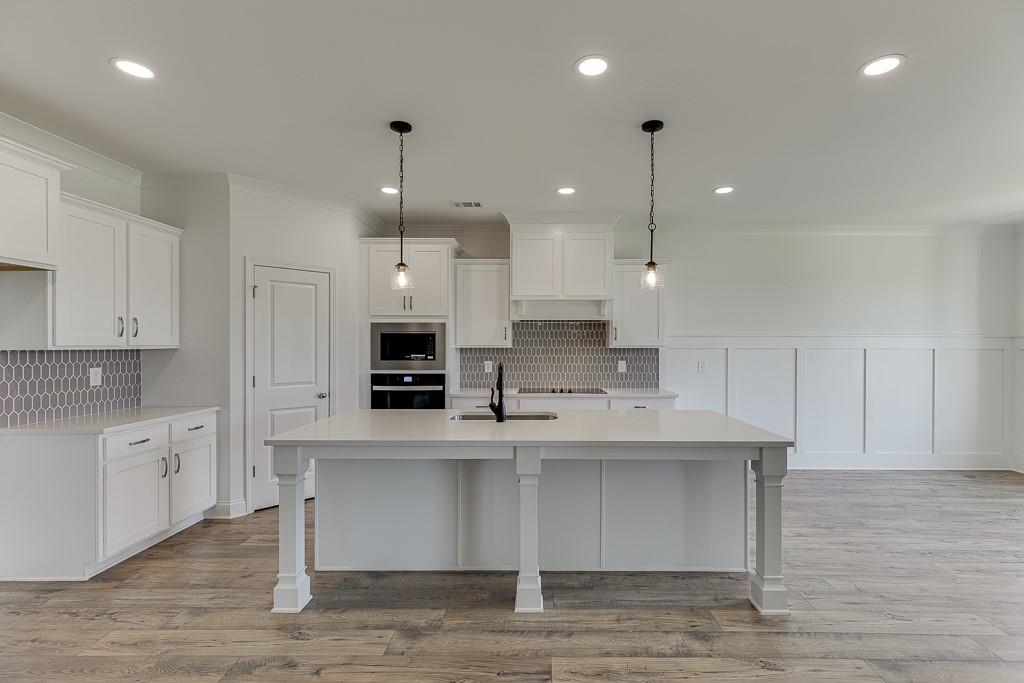 1123 Poppy Lane Jefferson, GA 30549 - Photo 15 of 45 a large kitchen with stainless steel appliances kitchen island a cabinets and a counter space