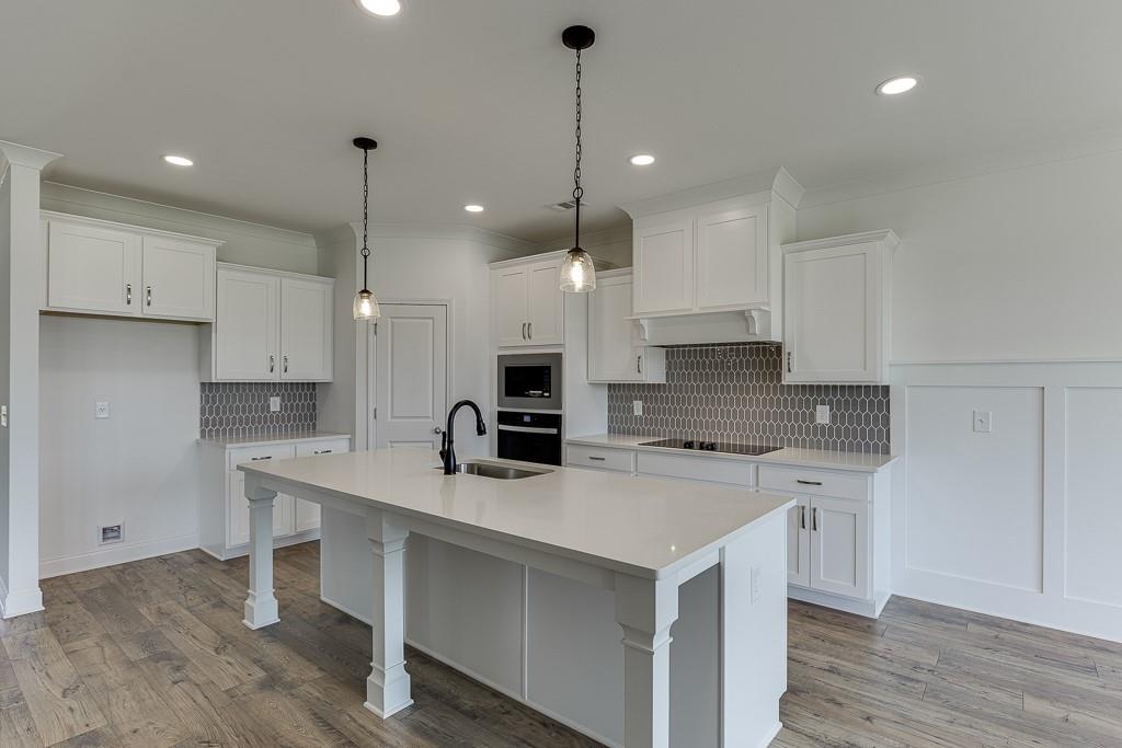 1123 Poppy Lane Jefferson, GA 30549 - Photo 16 of 45 a kitchen with kitchen island a sink stainless steel appliances and cabinets