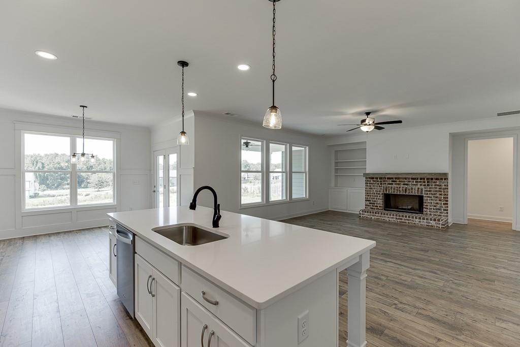 1123 Poppy Lane Jefferson, GA 30549 - Photo 19 of 45 a kitchen with a sink a large window and a fireplace