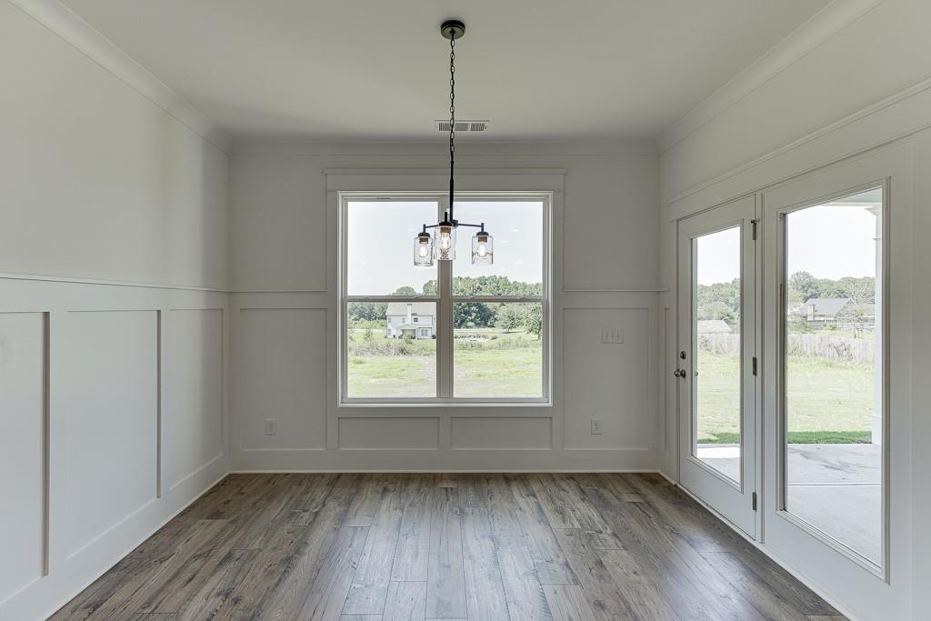1123 Poppy Lane Jefferson, GA 30549 - Photo 20 of 45 a view of an empty room with wooden floor and a window