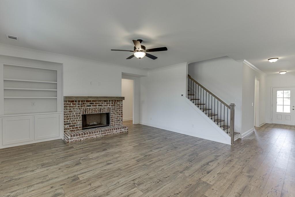 1123 Poppy Lane Jefferson, GA 30549 - Photo 23 of 45 a view of an empty room with wooden floor fireplace and a window