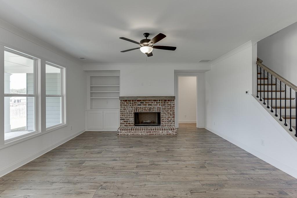 1123 Poppy Lane Jefferson, GA 30549 - Photo 24 of 45 an empty room with windows and a fireplace