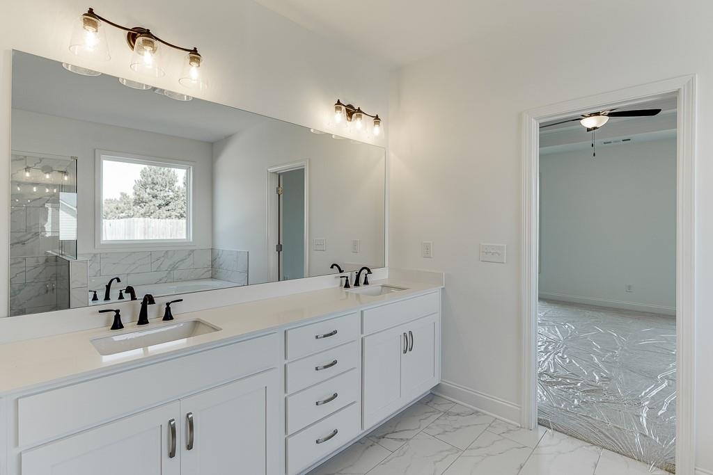 1123 Poppy Lane Jefferson, GA 30549 - Photo 33 of 45 a bathroom with double sink and a mirror