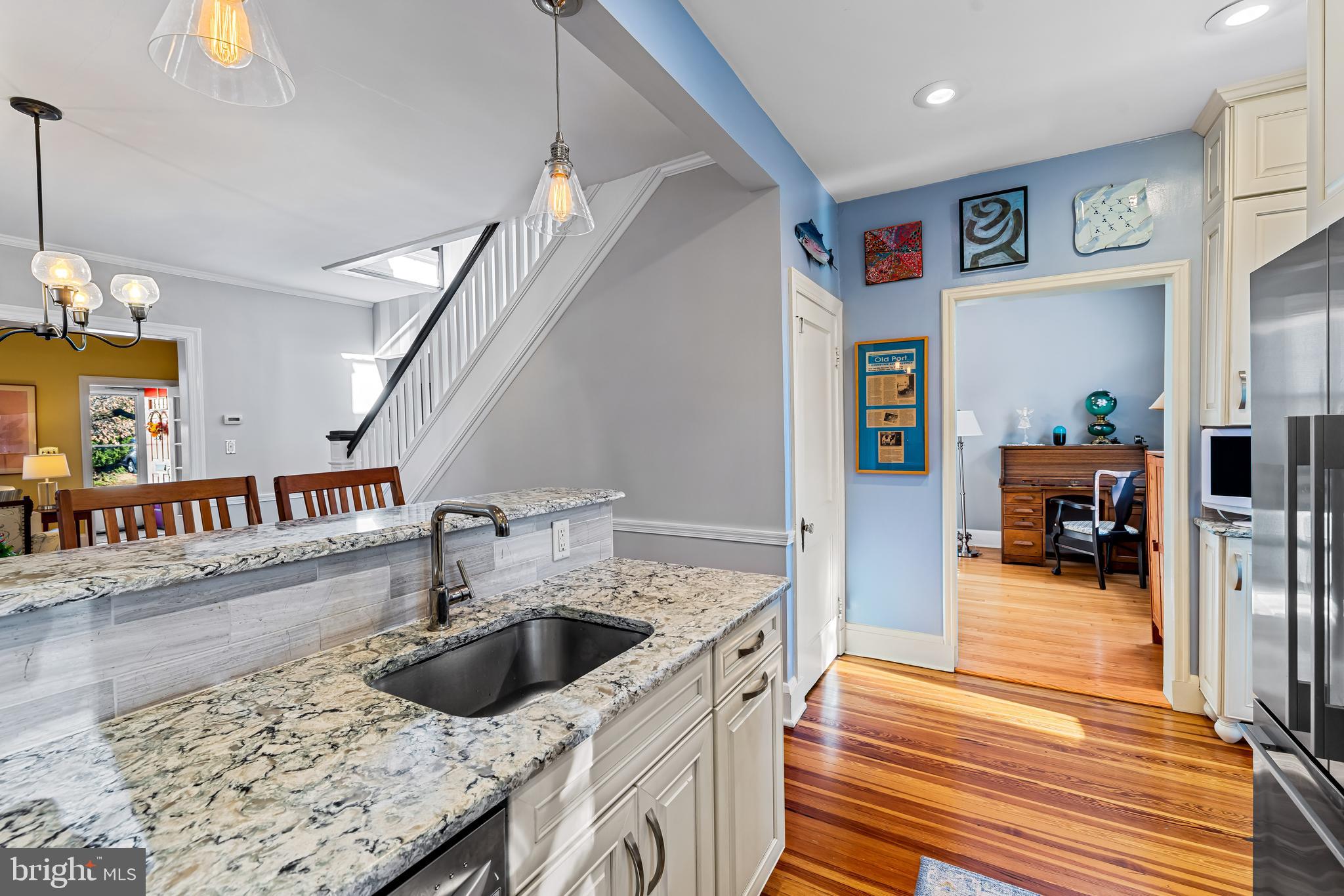 529 Overbrook Road Baltimore, MD 21212 - Photo 16 of 40 a kitchen that has a lot of cabinets and a wooden floor