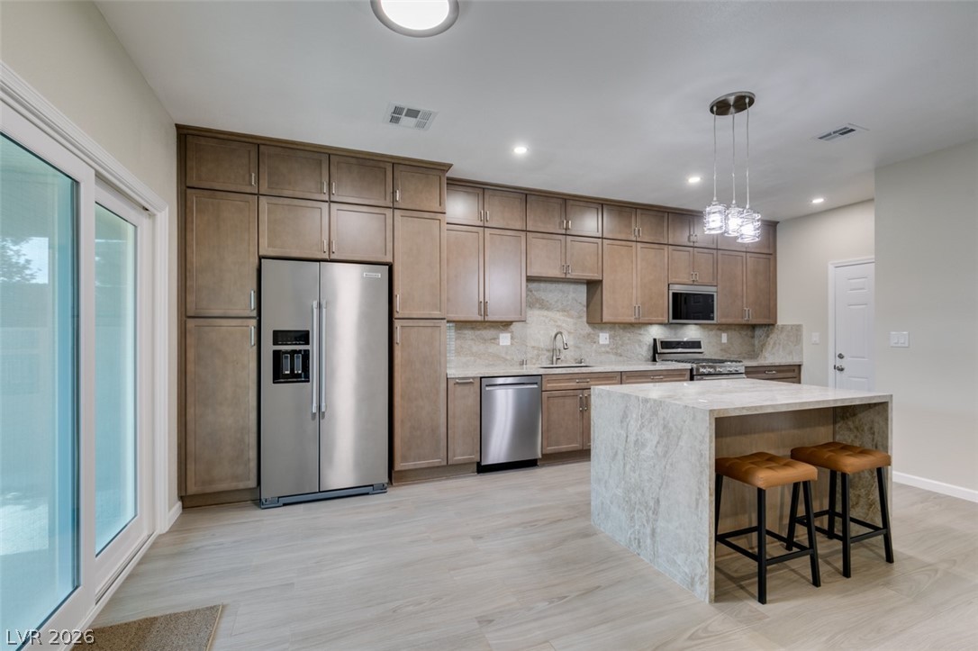 540 Sutters Mill Road Henderson, NV 89014 - Photo 22 of 46 This contemporary kitchen features generous cabinet space and a large island, perfect for entertaining.