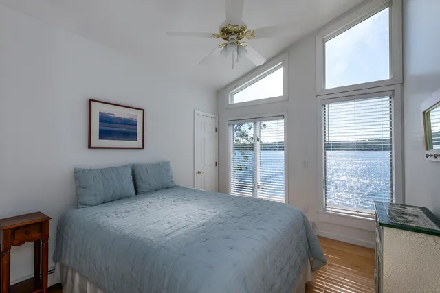 a bedroom with a large bed and a window