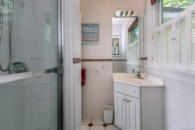 a bathroom with a sink toilet and shower