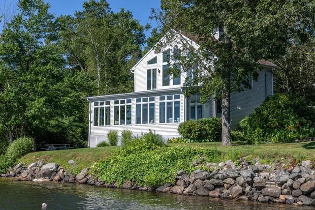 a house that has a lot of plants and trees in the background